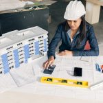 african-american-lady-safety-helmet-sitting-near-model-building